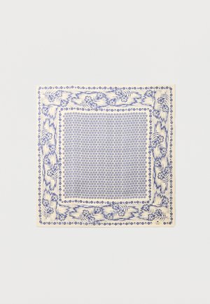 Kvadratni kremasti materijal s plavim cvjetnim rubom i gustim uzorkom malih plavih kružnih motiva u sredini.