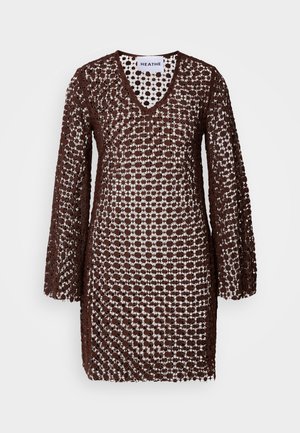 Brown crocheted dress with a V-neck, long sleeves, and a loose fit. Features a patterned design, allowing light to pass through.