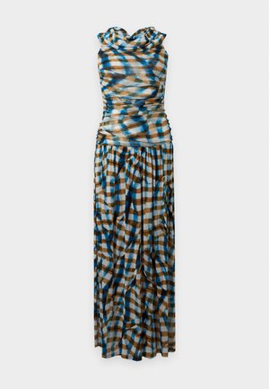 Woman standing wearing a long off-shoulder dress with a blue, brown, and white plaid pattern and black strappy high heels.