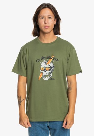 Olive green short-sleeve t-shirt featuring a graphic of a skull with sunglasses and a surfboard. Made of soft, lightweight material.