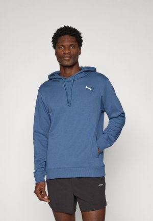 Sweatshirt à capuche bleu en mélange de coton, avec une poche kangourou à l'avant et un logo Puma blanc sur la poitrine gauche.