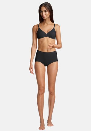 Black bra and high-waisted brief set. Bra has thin straps and a smooth texture; brief features a scalloped edge and a soft fabric.