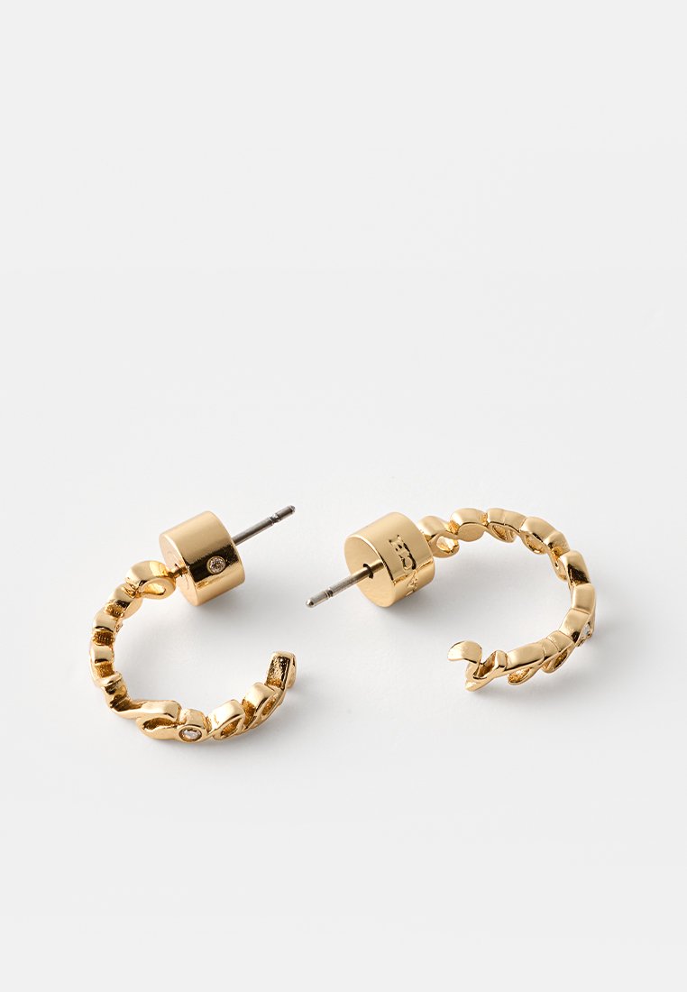 Pair of gold twisted hoop earrings with post backs and small embedded clear stones on a white background.
