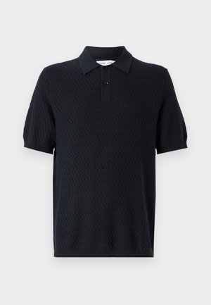 Black polo shirt with a textured zigzag pattern, short sleeves, and a collar featuring two buttons. Made from a breathable fabric.