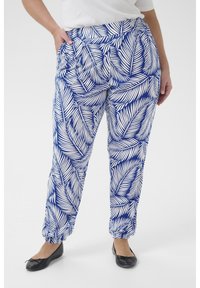 White and blue patterned pants featuring a tropical leaf design, elastic waistband, and ankle cuffs, made from a lightweight fabric.