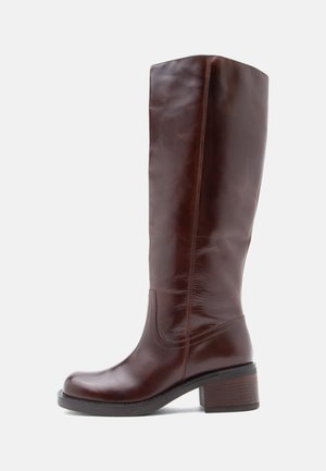 Brown leather knee-high boot with a rounded toe, subtle stitching, and a chunky heel. Smooth texture with a glossy finish.