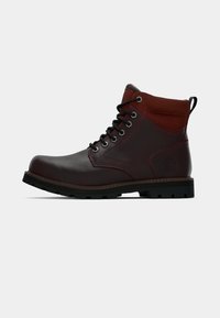 Dark brown leather ankle boot with black laces, padded maroon collar, durable black sole, and pull tab at the back.