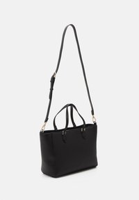 Black, structured tote bag made of smooth synthetic material. Features dual top handles and a detachable shoulder strap with gold hardware accents.