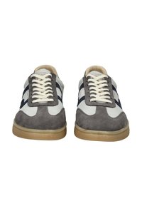 Pair of gray and white suede sneakers with cream laces and gum soles, viewed from the front on a white background.