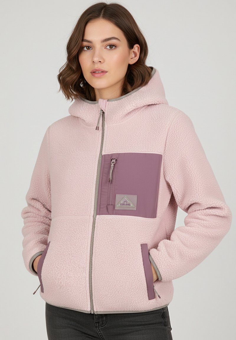 Fleece jacket in light pink with a hood. Features a purple chest pocket and gray accents. Zipper closure and side pockets. Soft texture.