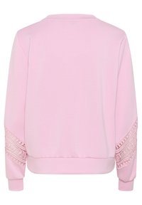 Rožinė megzta striukė ilgomis rankovėmis, su nėrinių akcentais ant rankovių, apvaliu iškirpimu ir prigludusia juosmens dalimi. Minkštas medžiagos tekstūra.