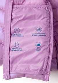 Das Innere der lila Jacke mit Etiketten für Wärmeisolierung, recycelte Fasern, Wasserabweisung und Weichheit, jeweils mit entsprechenden Symbolen.