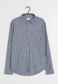 Chemise à manches longues bleu et blanche à carreaux en coton, avec un col boutonné, des boutons sur le devant et une poche poitrine.