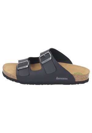 Black dual-strap slide sandal with silver buckles, cork footbed, and black sole, shown from the side on a white background.
