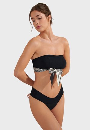 Black bikini with a strapless top featuring a patterned band and bow detail. High-waisted bottom in solid black, smooth texture.