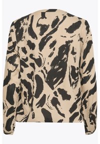 Blusa beige con un estampado abstracto negro, de manga larga y corte relajado. Confeccionada en una tela suave con un ligero brillo.