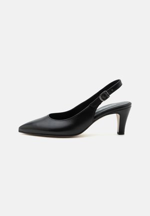 Zwarte leren slingback pump met spitse neus, verstelbare gespband en midhoge smalle hak op een effen achtergrond.