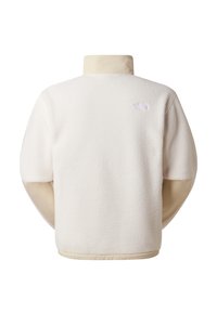 Kermanvärinen fleecetakki, jossa korkea kaulus ja leveät hihat. Takana yläosassa pieni logo ja teksturoitu kangaspinta.