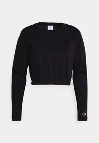 Felpa nera corta con maniche lunghe, orlo elastico e una piccola etichetta con logo sulla manica sinistra. Realizzata in morbido cotone con una texture liscia.