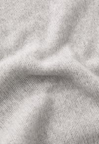Light gray knitted fabric with a soft, textured surface. The material shows a fine, even weave with subtle variations in shading.