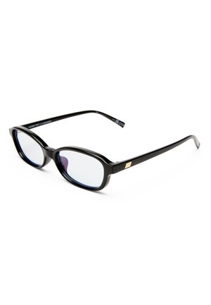 Μαύρα ορθογώνια γυαλιά με λεπτά σκελετούς και διαφανείς φακούς, τοποθετημένα σε γωνία σε λευκή επιφάνεια.