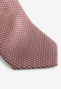 Burgundy silk tie featuring a geometric pattern in light and dark tones, with a polished texture and a classic tapered end design.