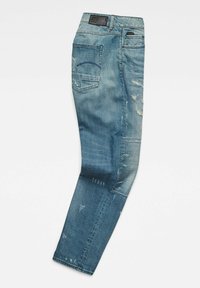 Blue denim jeans with a slim fit, featuring distressed details, a back pocket, and a black label on the waistband.