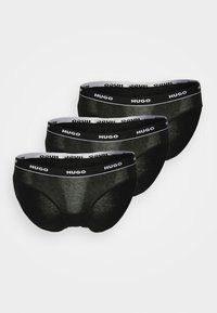 Ensemble de trois sous-vêtements en coton noir, avec une taille élastique douce arborant le logo "HUGO", texture lisse et design classique de slip.