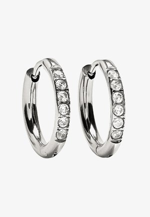 Srebrne kolczyki w kształcie kółek z gładkim wykończeniem i osadzonymi przezroczystymi cyrkoniami po jednej stronie, z bezpiecznym zapięciem.