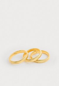 Gold-toned metal rings with a coiled design, featuring ribbed texture and a smooth finish. Three rings stacked together.