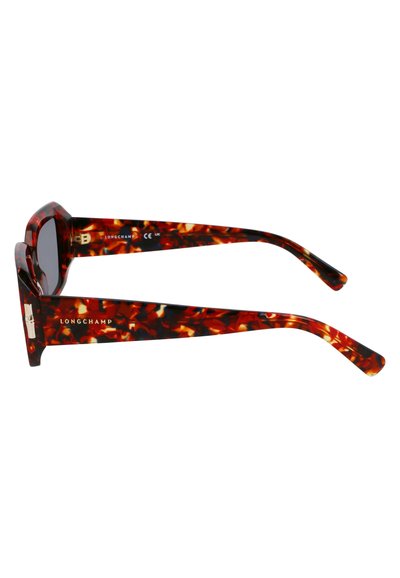 Lunettes de soleil en écaille de tortue avec une monture épaisse, dotées de verres foncés et d'accents en métal doré. Marquées "LONGCHAMP" sur les branches.