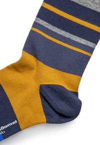 Striped sock featuring shades of navy, mustard, and gray. Material is a smooth knit with a reinforced toe and heel.