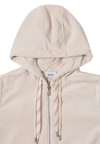Crème kleurige zip-up hoodie met ribbelstructuur. Heeft een capuchon, gestreepte trekkoorden en een merklabel aan de binnenkant.