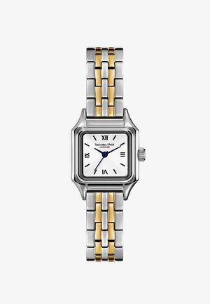 Stříbrně a zlatě tónovaný obdélníkový hodinky s bílým ciferníkem, římskými číslicemi a modrými ručičkami. Nerezový náramek se smíšenými kovovými články.