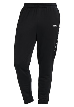Pantalons de sport noirs en tissu doux, avec une taille élastique, des jambes fuselées et un logo blanc à l'avant avec des accents de points sur les côtés.