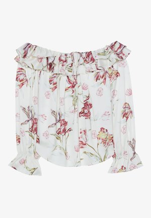 Blouse dénudée aux épaules en tissu blanc avec un motif floral rose et vert, présentant des poignets à volants et un col à cordon.