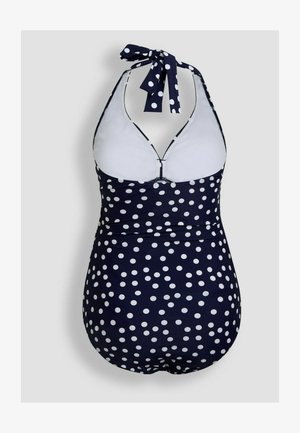 Laivansinis kokonainen uimapuku, jossa on valkoisia pilkkuja, kahlekauluksellinen malli, matala selkäosa ja erottuva valkoinen vuori.