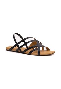 Schwarze Sandalen mit Riemchen und offener Zehenpartie, ausgestattet mit mehreren dünnen Riemen und einer flachen, beigen Sohle für Komfort. Minimalistisches und elegantes Design.