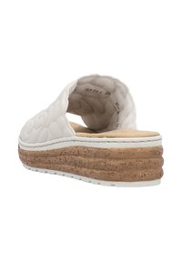 Sandale à semelle en mousse blanche avec un dessus texturé, dotée d'une semelle en liège et d'un contour en caoutchouc blanc. Conception ouverte à l'arrière pour un enfilage facile.