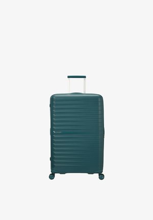 Valigia rigida turchese con scanalature orizzontali, quattro ruote girevoli e manico telescopico estensibile.