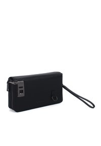 Black textured leather wallet clutch with a zip closure, a metal accent, and a wrist strap. Features a minimalistic design and logo detail.