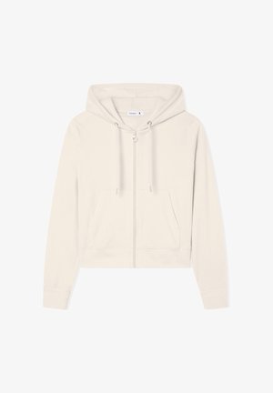 Przycięta, jasnobeżowa bluza z kapturem, wykonana z miękkiego materiału, z suwakiem z przodu, dwiema kieszeniami z przodu oraz sznurkami do regulacji na kapturze.