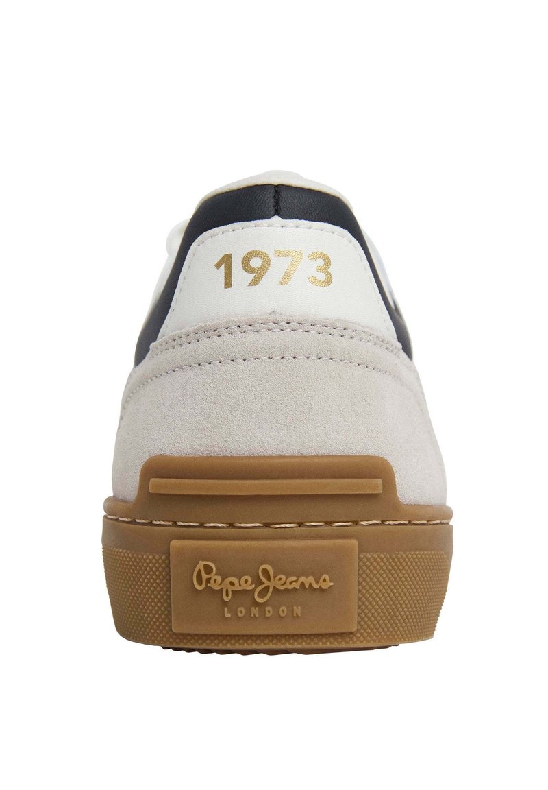 Der Sneaker verfügt über ein weißes Obermaterial mit grauen Wildlederüberzügen, schwarzen Akzenten und einem goldenen "1973" Druck. Gummisohle mit strukturiertem Grip und Logo.