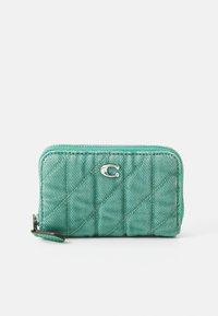 Quilted mint green wallet with silver hardware, diagonal stitching, and a zipper closure. Features a small loop for easy carrying.