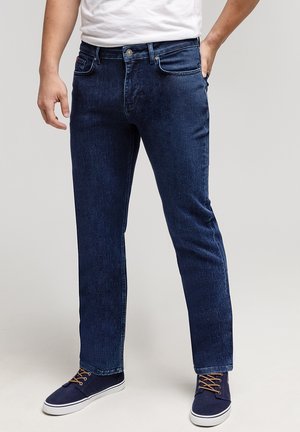 Jasnoszare dżinsy w ciemnoniebieskim kolorze, prosty krój z delikatnym wyblakłym odcieniem. Posiadają klasyczne szlufki na pasek, kieszenie z przodu oraz zapięcie na guzik.