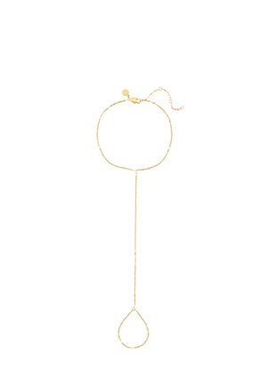 Delicate gold hand chain with a bracelet linked to a loop designed to fit around a finger, displayed on a white background.