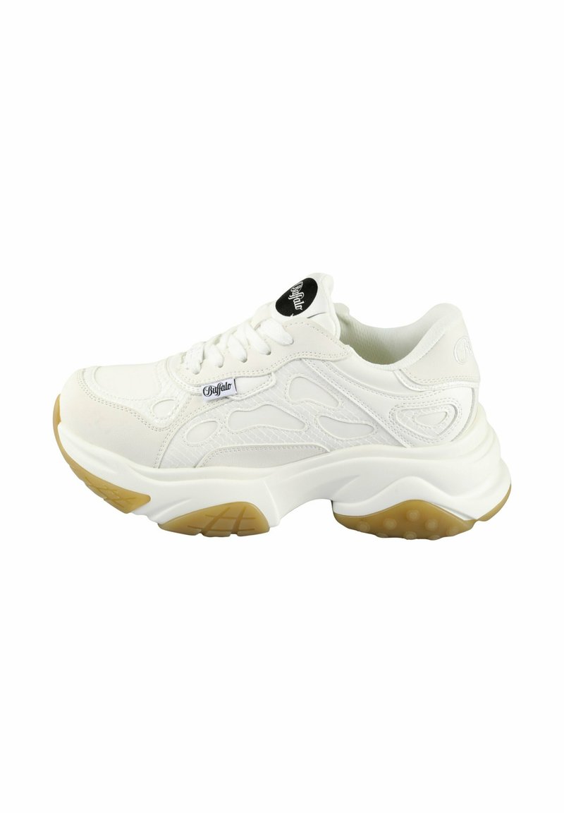 White sneaker with textured leather upper, lace-up closure, and a thick sole featuring a gum rubber accent. Notable design lines on sides.