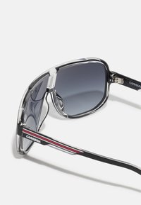 Prillid läbipaistva raamiga, halli gradient-tuumaga, mustade aktsentidega ja punaste detailidega kätel. Omab ristkülikukujulist vormi ja tugevaid hinged.