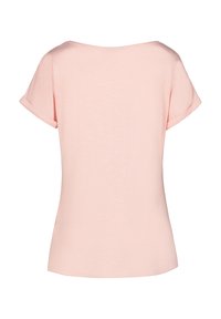 Camiseta de color rosa claro, con escote en U, mangas cortas con dobladillo, tela suave, corte relajado, dobladillo recto con laterales abiertos en la parte inferior.