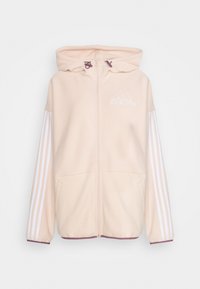 Světle růžová mikina na zip vyrobená z měkkého materiálu, s bílými pruhovanými rukávy, kapucí se stahovacími šňůrkami a malým logem na hrudi.